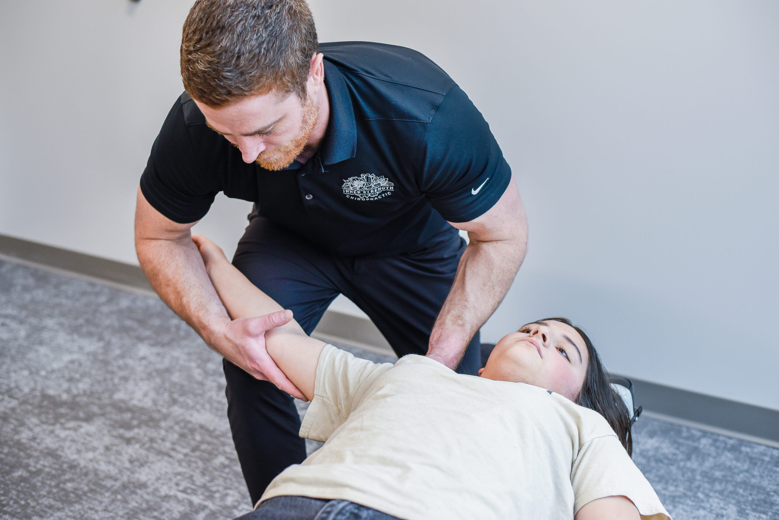 Dr. Joe McLeighton adjusting a patient's shoulder at Inner Strength Chiropractic in Franklin, TN